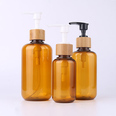 Amber Glass Bamboo Cosmetic Bottle con lo spruzzatore di legno della lozione dell'incisione del cappuccio